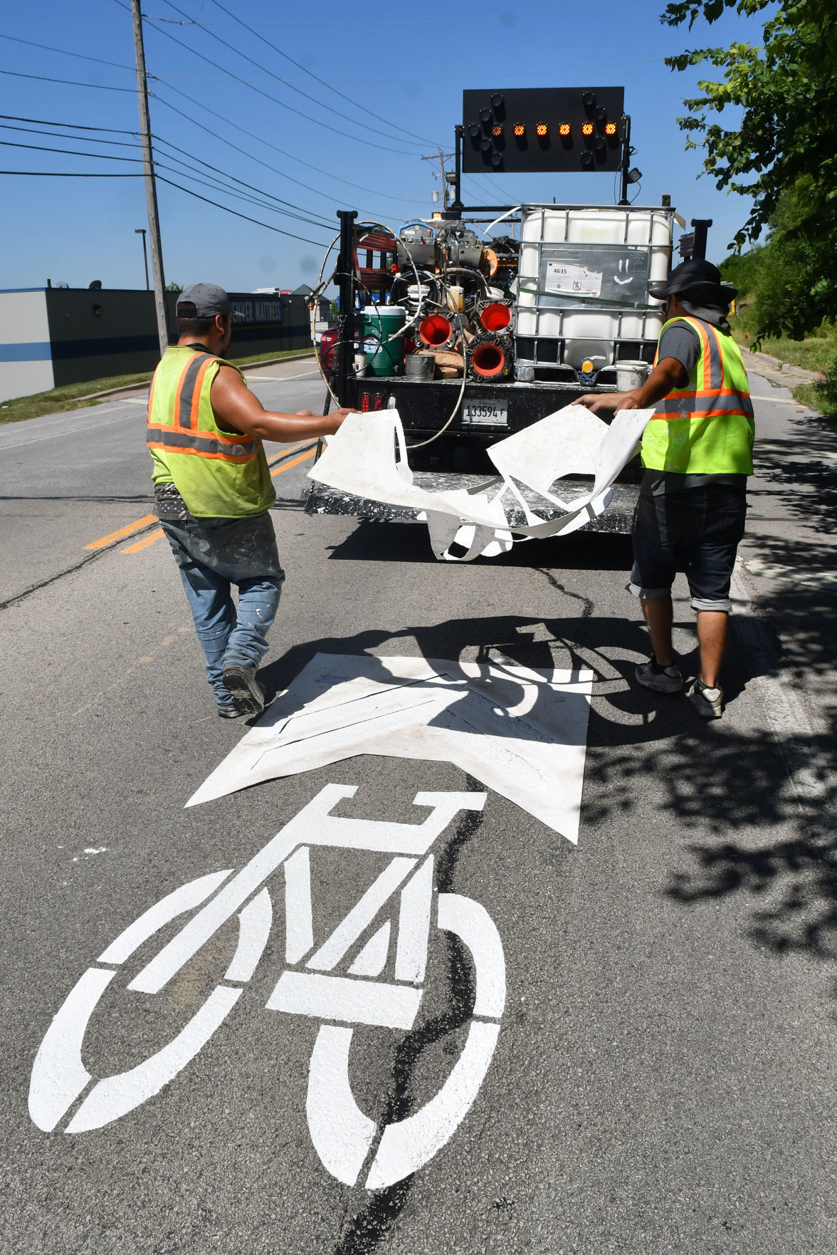 Painting of sharrows for bike lanes in Moline.